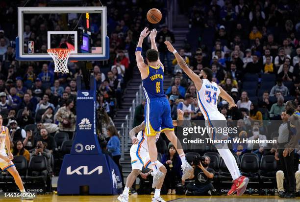 Klay Thompson of the Golden State Warriors shoots a three-point shot over Kenrich Williams of the Oklahoma City Thunder during the third quarter at...