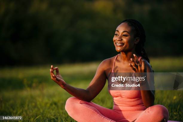 woman praying alone at sunset - practice gratitude stock pictures, royalty-free photos & images