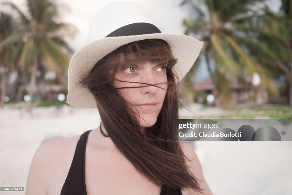 Girl on the beach with blowing hair.