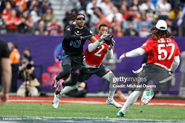 Cornerback Patrick Surtain II of the Denver Broncos intercepts the ball against NFC wide receiver Justin Jefferson of the Minnesota Vikings during an...