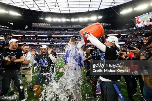 Running back Christian McCaffrey of the San Francisco 49ers and NFC defensive end Cam Jordan of the San Francisco 49ers celebrate as they dump water...