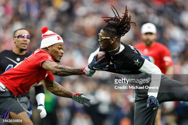 Wide receiver CeeDee Lamb of the Dallas Cowboys evades a tag against AFC strong safety Derwin James of the Los Angles Chargers and runs for a...