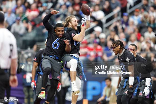 Tight end T.J. Hockenson of the Minnesota Vikings celebrates with NFC free safety Quandre Diggs of the Seattle Seahawks after scoring a touchdown...