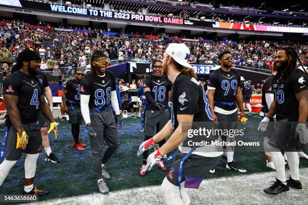 Tight end T.J. Hockenson of the Minnesota Vikings dances as NFC running back Dalvin Cook of the Minnesota Vikings, NFC wide receiver CeeDee Lamb of...