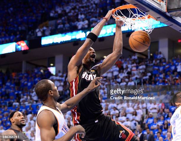 Chris Bosh of the Miami Heat dunks the ball over Serge Ibaka of the Oklahomia City Thunder in the fourth quarter in Game Two of the 2012 NBA Finals...