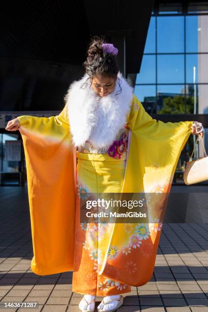 a girl is wearing a kimono and participating in the coming-of-age ceremony - seijin no hi stock pictures, royalty-free photos & images