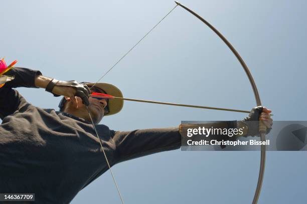 archer drawing longbow - archer stock pictures, royalty-free photos & images