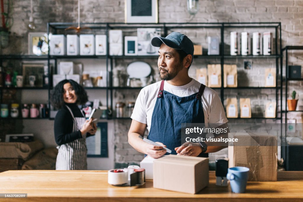 Coffee shop owner packs a box of his freshly roasted coffee