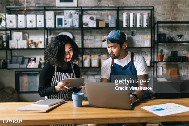 small business owners working behind cafe counter - business owner laptop stock pictures, royalty-free photos & images