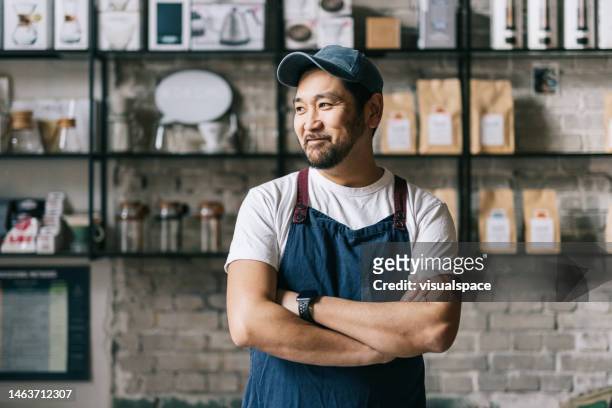 コーヒー焙煎所に立つ自信に満ちた日本人オーナー - 自然な ストックフォトと画像