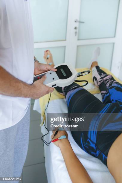 using instrument with monitor for electrostimulation therapy - electromagnetic stock pictures, royalty-free photos & images