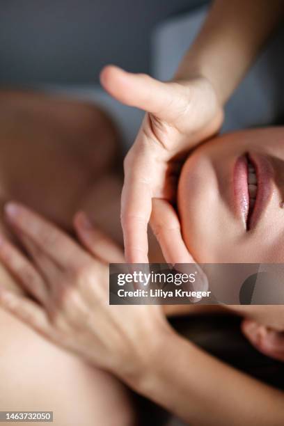 skin care treatment in spa salon, woman getting massage. - woman hand face photos et images de collection