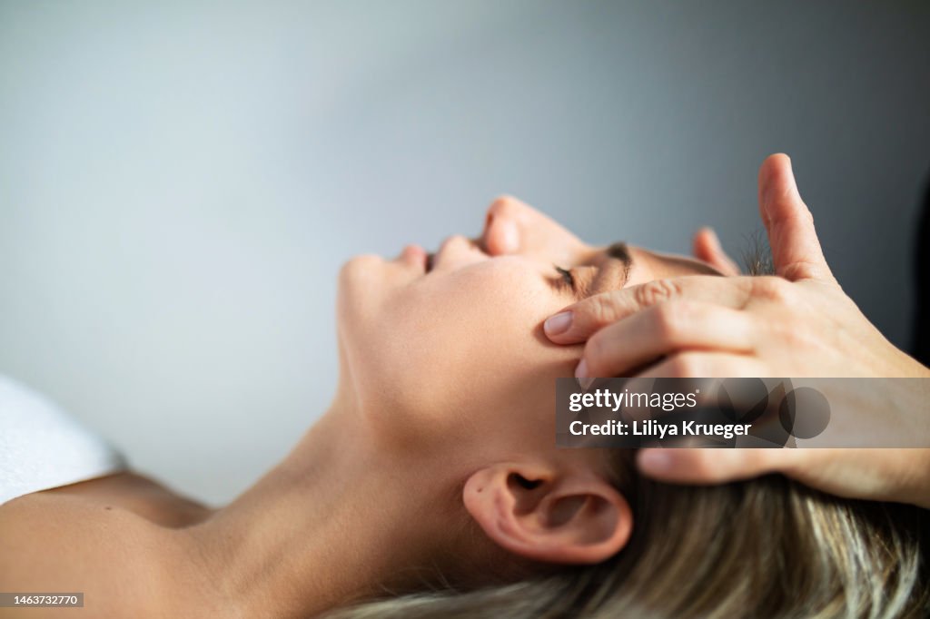 Skin care treatment in spa salon, woman getting massage.