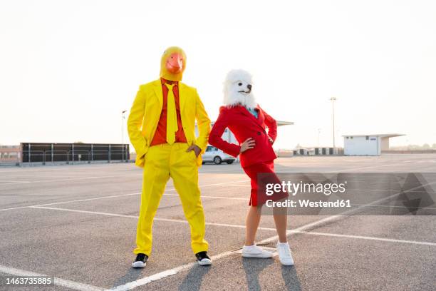 playful friends in costumes dancing at parking lot - mask disguise imagens e fotografias de stock