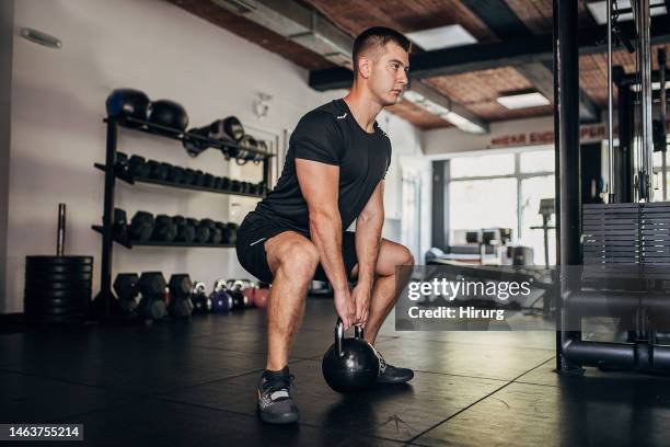 man weightlifting in gym - kettle bell stock pictures, royalty-free photos & images