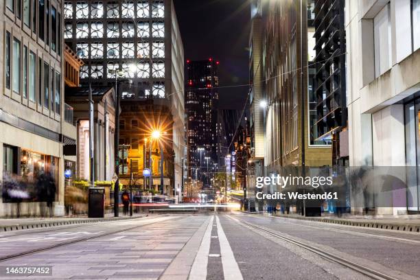 uk, england, manchester, long exposure of city street at night - manchester england stock pictures, royalty-free photos & images