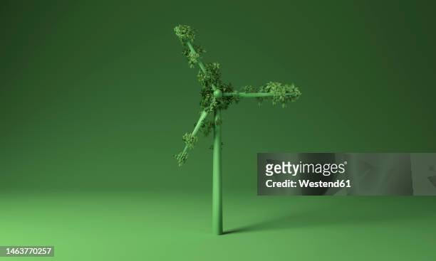 illustration of wind turbine covered with plants over green background - technology stock illustrations