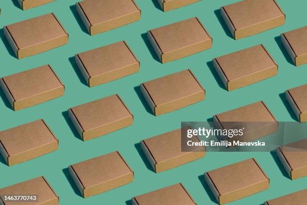 closed blank cardboard box on green - empty cardboard box stock pictures, royalty-free photos & images