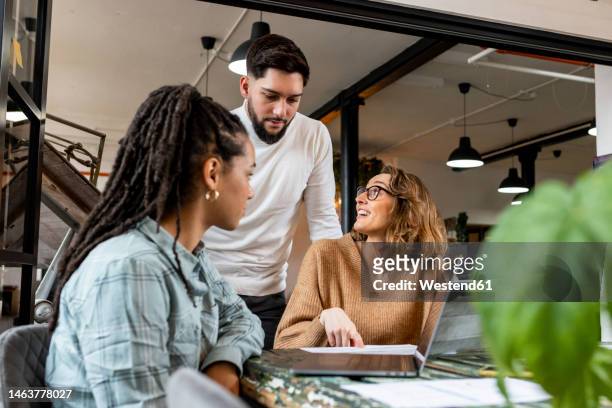 happy businesswoman with coworkers sitting in office - enterprise stock pictures, royalty-free photos & images