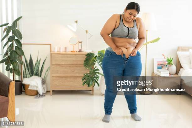 trying to wear tight jeans - perfect female body shape stock pictures, royalty-free photos & images