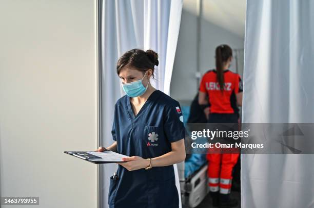 Polish nurse, Natalia, aged 24, carries diagnostic papers from A Ukrainian cancer patient at the Medevac HUB Jasionka on February 06, 2023 in...