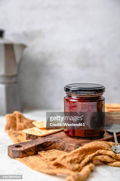 homemade strawberry jam in jar with crackers - strawberry jam stock pictures, royalty-free photos & images