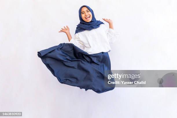 teenage girl jump - islamic action front stock pictures, royalty-free photos & images