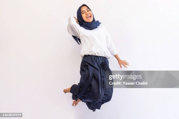 teenage girl jump mid air - islamic action front stock pictures, royalty-free photos & images