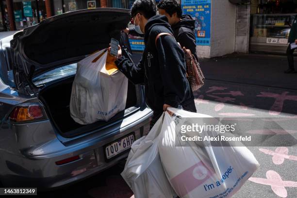People carrying shopping, pack bags into an Uber in the Central Business District 'CBD' on February 07, 2023 in Melbourne, Australia. On July 6, 2022...