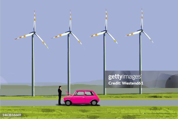 illustration of man dealing with vehicle breakdown in front of wind farm turbines - distraught stock illustrations