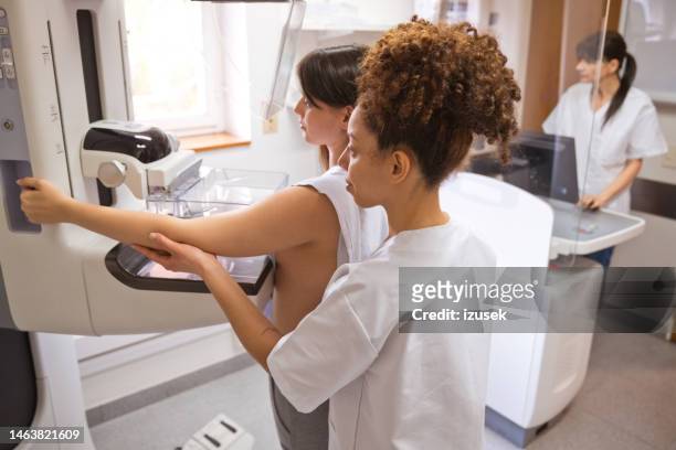 female doctor and patient during mammography test in examination room - mammogram diversity stock pictures, royalty-free photos & images