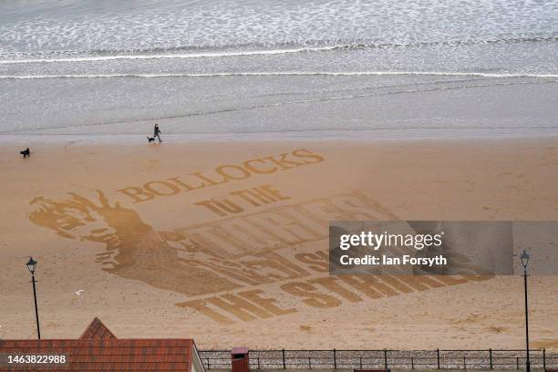 Piece of sand art appears on Saltburn beach supporting strike action on February 07, 2023 in Saltburn By The Sea, England.