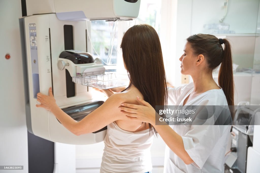 Nurse and patient during Mammography test in examination room
