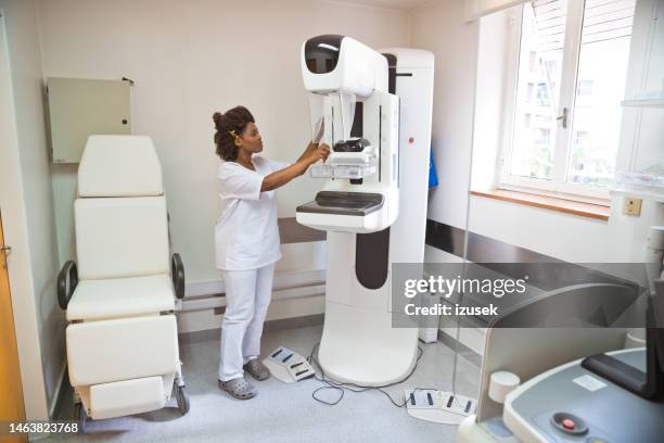 young nurse standing in examination room - mammogram stock pictures, royalty-free photos & images
