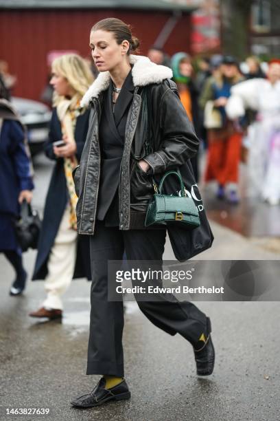 Guest wears a black wrap blazer jacket, a black shiny leather with white sheep collar coat, a green shiny leather crocodile print pattern Hourglass...