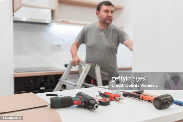 handyman having tool scattered on a table - handyman stockfoto's en -beelden