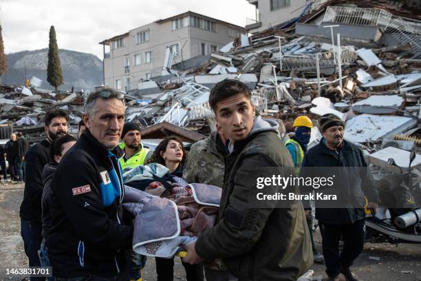 Rescue workers carry a survivor at the site of a collapsed building on February 07, 2023 in Hatay Turkey. A 7.8-magnitude earthquake hit near...