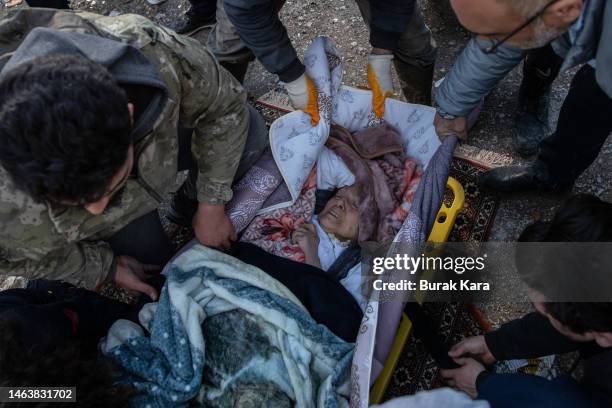 Rescue workers carry a survivor at the site of a collapsed building on February 07, 2023 in Hata Turkey. A 7.8-magnitude earthquake hit near...