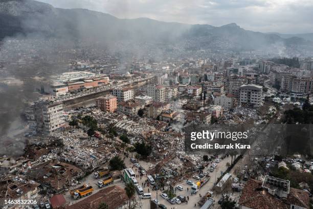 Smoke billows from the scene of a collapsed buildings on February 07, 2023 in Hatay, Turkey. A 7.8-magnitude earthquake hit near Gaziantep, Turkey,...