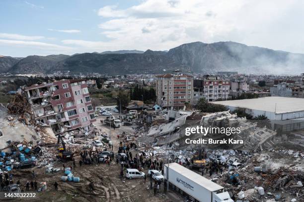 Smoke billows from the scene of a collapsed buildings on February 07, 2023 in Hatay, Turkey. A 7.8-magnitude earthquake hit near Gaziantep, Turkey,...