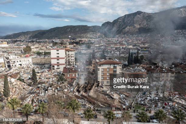 Smoke billows from the scene of a collapsed buildings on February 07, 2023 in Hatay, Turkey. A 7.8-magnitude earthquake hit near Gaziantep, Turkey,...