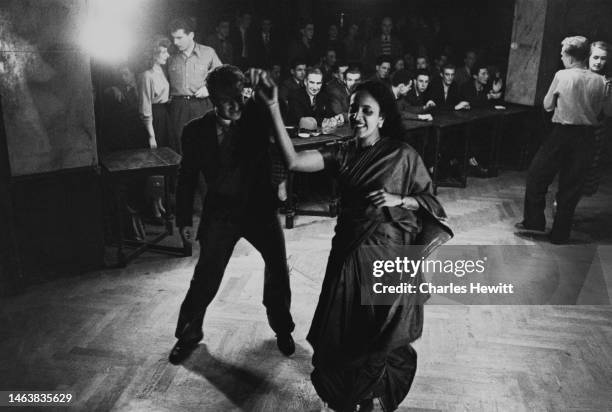 Couple dancing to Humphrey Lyttelton and his band at the London Jazz Club, later to become the 100 Club on Oxford Street, the lady is wearing a sari,...