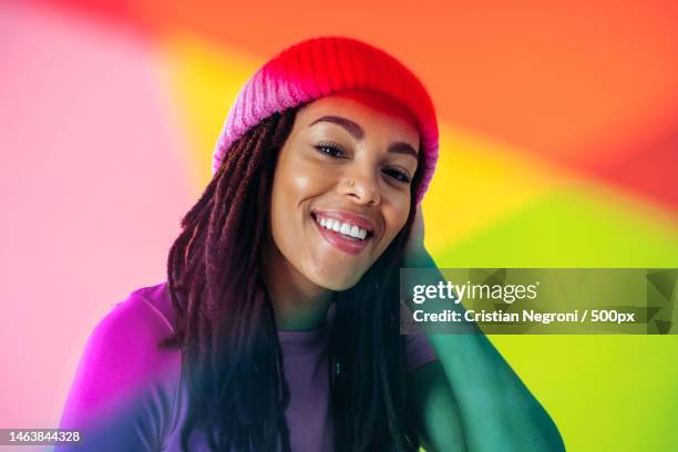 woman posing on colored backgrounds in studio wearing trendy clothes - gel effect lighting stock pictures, royalty-free photos & images