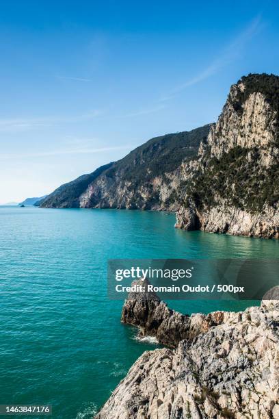 scenic view of sea and mountains against blue sky,portovenere,la spezia,italy - rocky coastline stock pictures, royalty-free photos & images