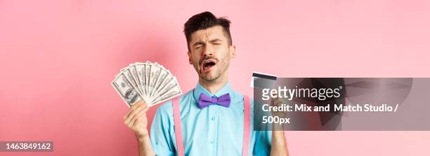 sad crying man looking miserable,showing plastic credit card and - ugly people crying stock pictures, royalty-free photos & images