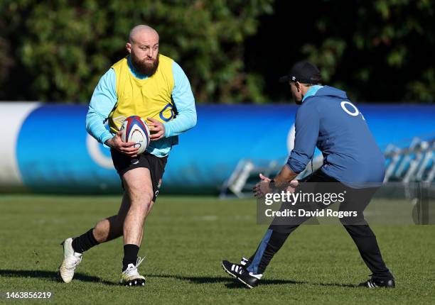 Tom Dunn takes on England attack coach, Nick Evans during the England training session at Pennyhill Park on February 07, 2023 in Bagshot, England.