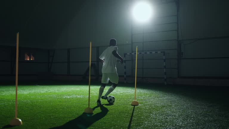 Running In Football active sportsman running in football training hall, african man ...