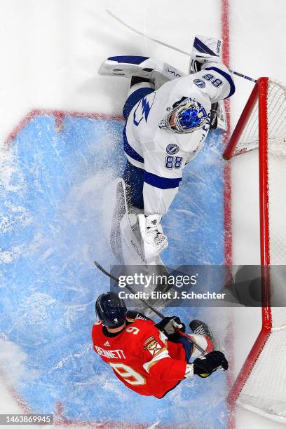 Goaltender Andrei Vasilevskiy of the Tampa Bay Lightning defends the net against Sam Bennett of the Florida Panthers at the FLA Live Arena on...