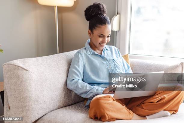 relaxed work on laptop at home by the window - laptop home stock pictures, royalty-free photos & images