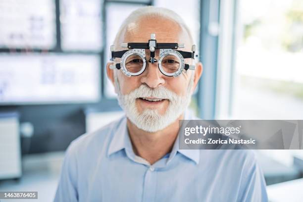 mature man doing eyesight measurement - phoroptor stock pictures, royalty-free photos & images